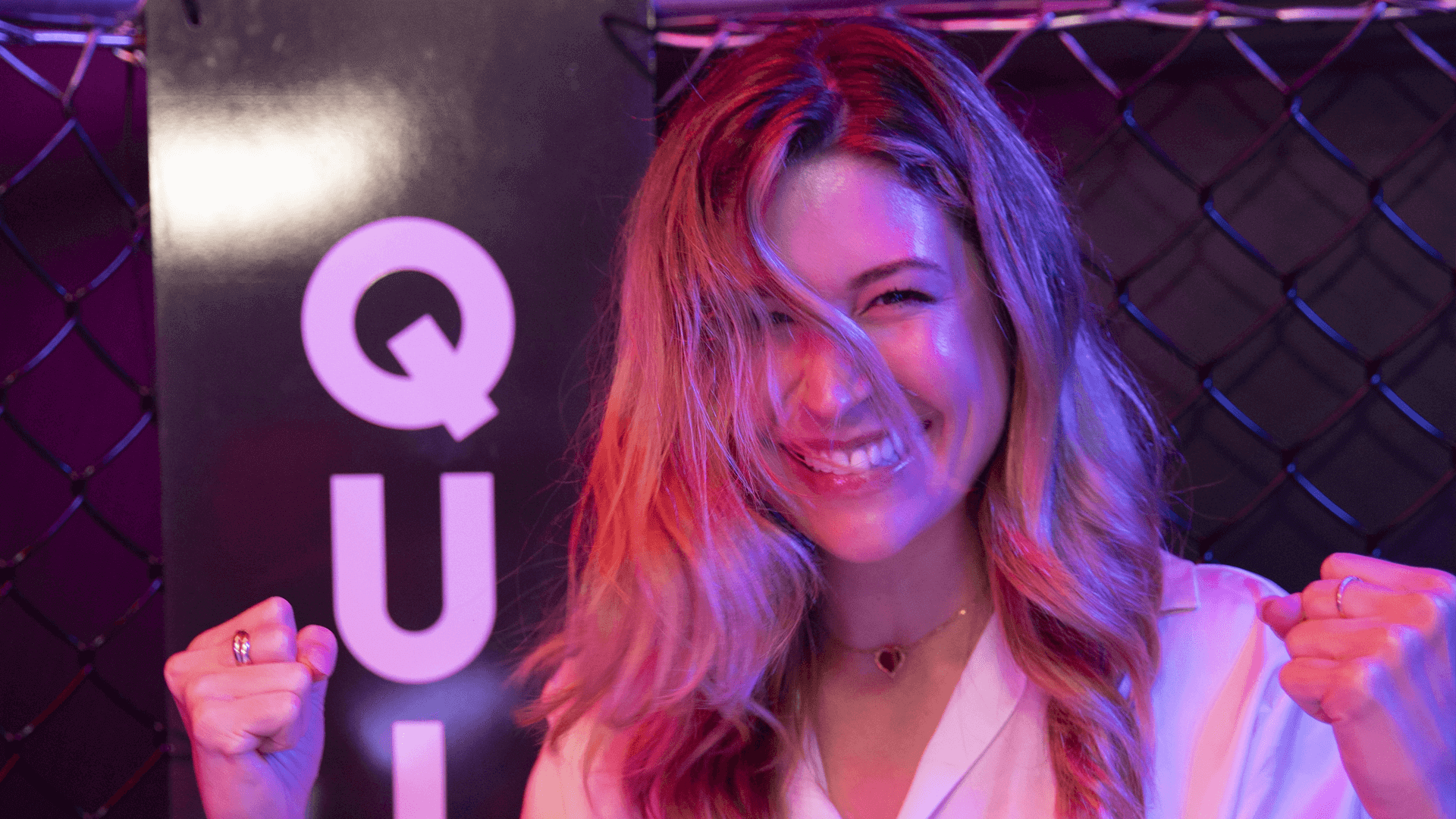 a woman posing with a smile on her face after taking part in Quiz Boxing